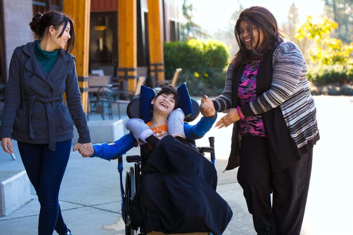 Child receiving supportive care from caregivers